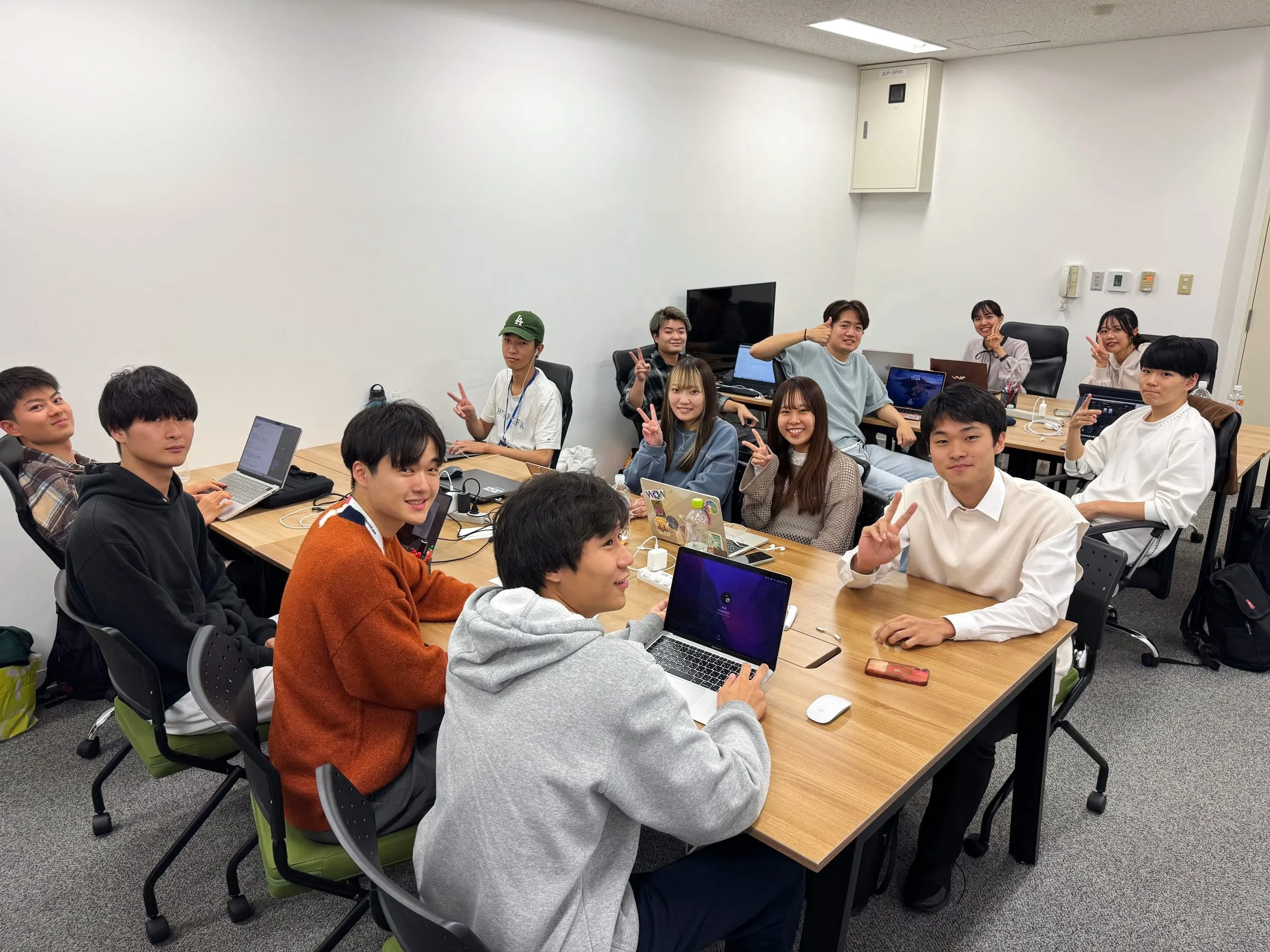 オフィスでノートPCを使って作業する学生メンバー